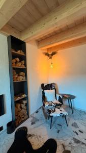 a living room with a chair and a table at Maso K - Il Gufo Dorato in Folgaria