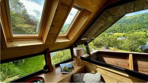 a room with three windows and a table with a lamp at Le 36 Chalet 6 pers Le Mont-Dore Sauna Ski Hiking in Mont-Dore