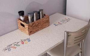a white table with a basket on top of it at BLE apartments in Ireon