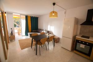 a kitchen and living room with a table and a refrigerator at Casa Luminaria in Costa Del Silencio +5 photos