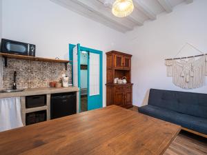 a living room with a table and a blue couch at El Conventillo de San Roque in San Roque