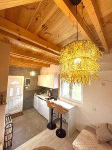 a kitchen with a table and a chandelier at Lux Montis in Ninkovići