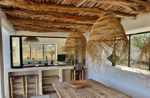 a kitchen with a counter with a sink and windows at Palais Bleu Nomade Essaouira in Aït Imouni