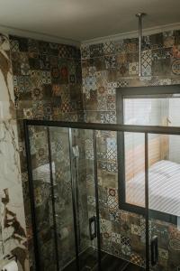 a bathroom with a window and a tiled wall at Golyaka Stone Garden Hotel in Orhangazi +46 photos