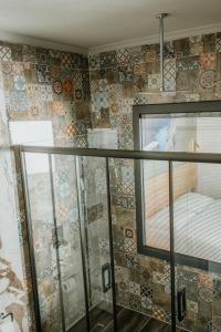 a room with a balcony with tiles on the wall at Golyaka Stone Garden Hotel in Orhangazi
