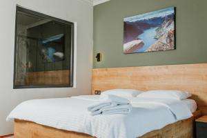 a bedroom with two beds with white sheets at Golyaka Stone Garden Hotel in Orhangazi