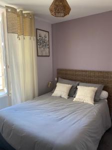 a bedroom with a large bed with two pillows at L'oustal del païs in Rilhac-Xaintrie +7 photos