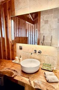 a bathroom with a white sink on a wooden counter at La Maison Moutchic in Lacanau +30 photos