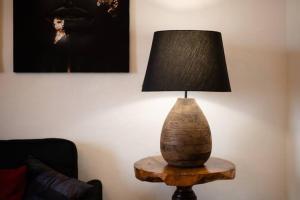 a lamp on a wooden table in a living room at Peaceful Hub Saturnia in Manciano