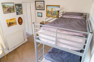 a bunk bed in a room with pictures on the wall at George Street Beverley in Beverley