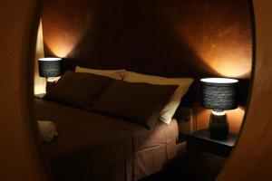a bedroom with a bed with two lamps on it at Peaceful Hub Saturnia in Manciano