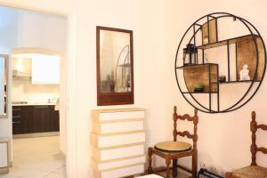 a living room with a mirror and a chair at Peaceful Hub Saturnia in Manciano +8 photos