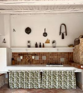 a kitchen with a counter with a stove top oven at Villa Pantalica lato Sortino in Sortino