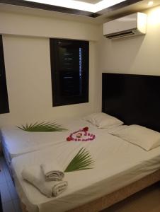 a bedroom with a bed with towels on it at Villa Silia in Sharm El Sheikh