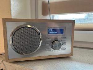 a small silver radio sitting on the floor at Ferienwohnung Ritthoff Perlebucht - mit Strandkorb am Meer und kostenloser Eintritt ins Schwimmbad in Büsum +36 photos