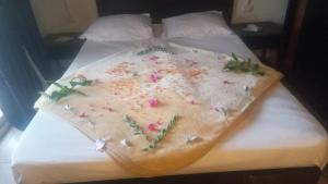 a cake on a bed with flowers on it at Villa Silia in Sharm El Sheikh