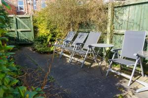 a row of chairs and tables in a garden at George Street Beverley in Beverley