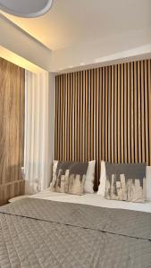 a bedroom with a large bed with a wooden wall at Balconya in Kavala
