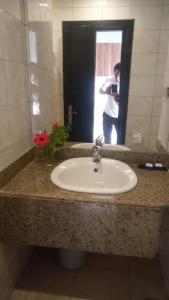 a man taking a picture of a sink in a bathroom at Villa Silia in Sharm El Sheikh