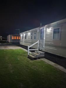 a mobile home with stairs in a yard at night at G26 kirbys Retreat 2 in Skegness