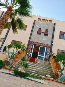 a house with palm trees in front of it at Villa Silia in Sharm El Sheikh