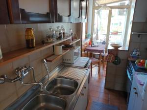 a kitchen with a sink and a microwave at Apartment Trieste Casa Vacanze NATASCIA in Trieste +68 photos