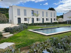 a house with a swimming pool in the yard at Le Cinglé du Ventoux in Malaucène
