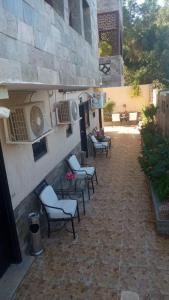 a group of chairs and tables on a patio at Villa Silia in Sharm El Sheikh