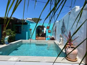 a swimming pool in front of a blue house at Let´s go to Valhalla in Chiclana de la Frontera