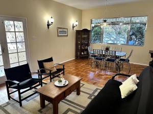 a living room with a couch and chairs and a table at Casa Amarela in Conservatória