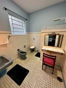 a bathroom with a toilet and a sink and a toilet istg at Casa Amarela in Conservatória +26 photos