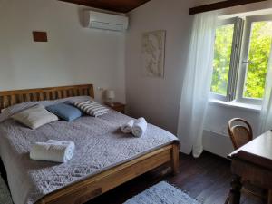 a bedroom with a bed with towels on it at Holiday house Maja in Baška