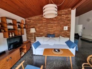 a bedroom with a large bed and a brick wall at Holiday house Maja in Baška