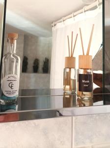 two bottles of perfume sitting on a glass shelf at Ammoudeli Coastal Escape in Plomari