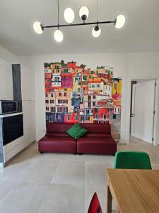 a living room with a large painting on the wall at Da Camilla in Cagliari