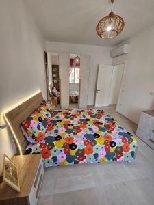a bedroom with a large bed with a colorful comforter at Da Camilla in Cagliari