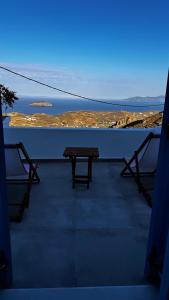 a bench on a balcony with a view of the ocean at Houses of chora in Serifos Chora