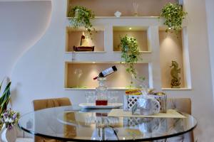 a glass table in a room with plants on shelves at Sykea Luxury Apartment in Xylokastro
