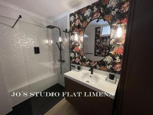 a bathroom with a sink and a mirror at Jo's Studio Flat Limens in Cangas de Morrazo +22 photos