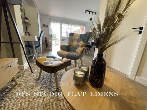 a living room with a vase of flowers on a table at Jo's Studio Flat Limens in Cangas de Morrazo