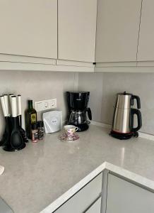 a kitchen counter with a coffee maker and a coffee pot at Mama Saggio Home in Fethiye