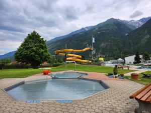 a pool of water with a slide in a park at Apartment Ad Alta Obervellach in Obervellach