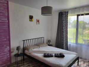 a bedroom with a bed with shoes on it at Torgai Hotel Apartments in Ureki