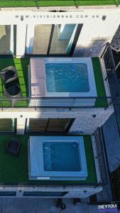 an overhead view of a swimming pool in a house at Vivisierras, Duplex a estrenar con pileta privada centro Villa Carlos Paz, 3 dormitorios, 2 baños, vista in Villa Carlos Paz