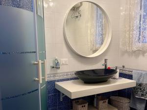 a bathroom with a black sink and a mirror at Terrazza Merope in Torre dell'Orso +26 photos