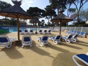 a group of chairs and umbrellas next to a pool at Harmonie in Calvisson