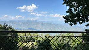 a view of a mountain valley from a fence at Murree - Bhurban Apartment with Private Balcony in Bhurban