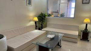 a living room with a couch and a table at Murree - Bhurban Apartment with Private Balcony in Bhurban +6 photos