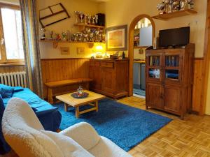 a living room with a couch and a table at Residenza Zeno Abetone in Abetone