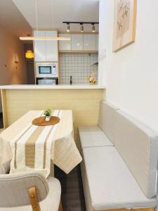 a small kitchen with a table and chairs and a counter at Vista Bangi Muji-styled 3BR Sunrise view in Kajang